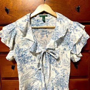 Ruffled light weight capped sleeve shirt.